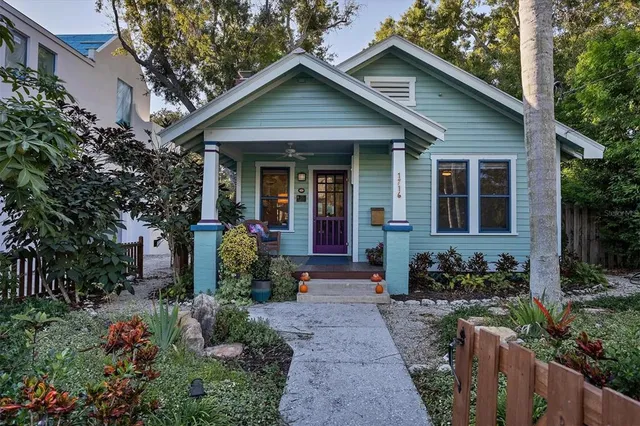 a front view of a house with potted plants