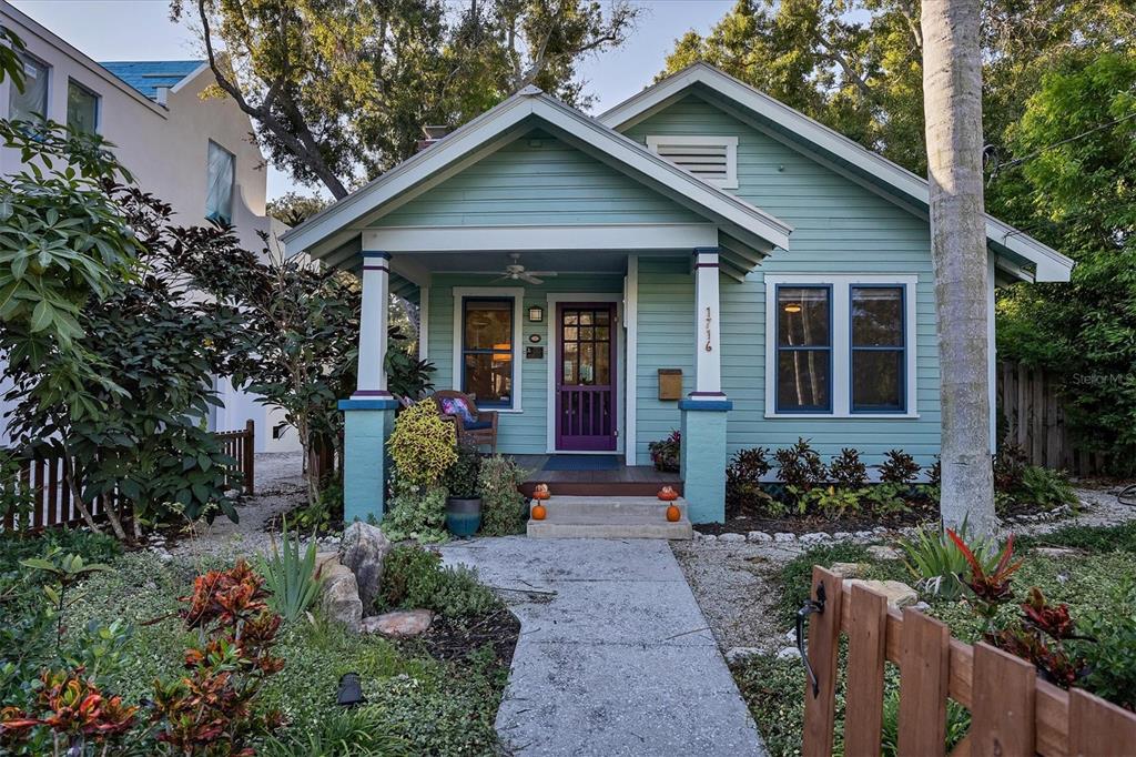 a front view of a house with potted plants