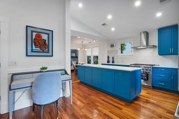 a kitchen with stainless steel appliances granite countertop a sink wooden cabinets and a granite counter tops
