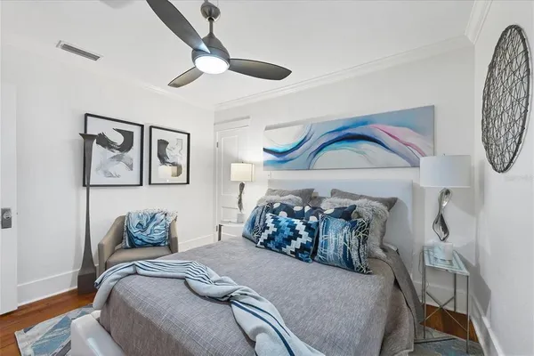 a bedroom with a bed and a chandelier