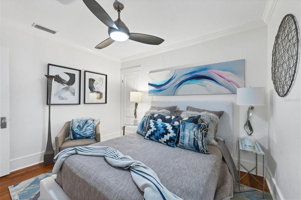 1716 Oak Street Sarasota, FL 34236 - Photo 16 of 49 a bedroom with a bed and a chandelier