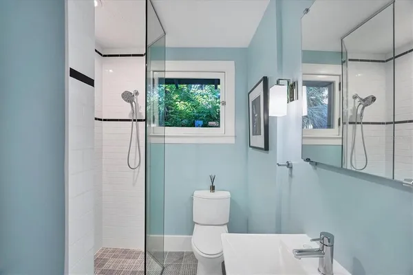 a bathroom with a toilet sink and shower