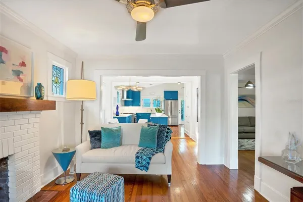 a living room with furniture and wooden floor
