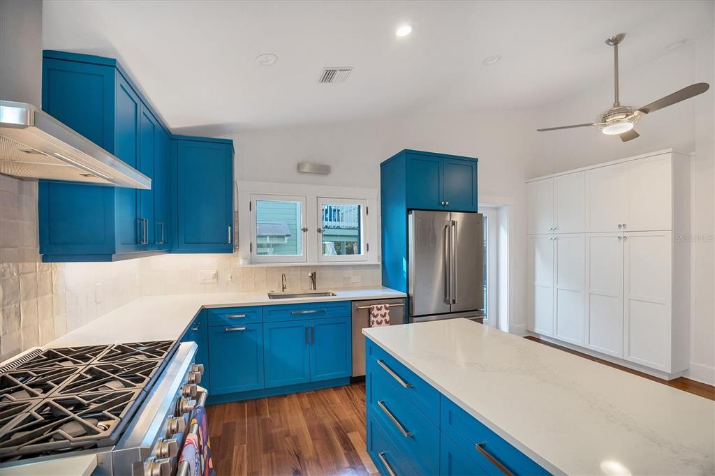 1716 Oak Street Sarasota, FL 34236 - Photo 9 of 49 a kitchen with a refrigerator a stove and wooden floor
