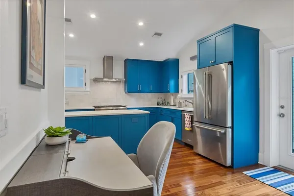 a kitchen with stainless steel appliances granite countertop a refrigerator sink and microwave