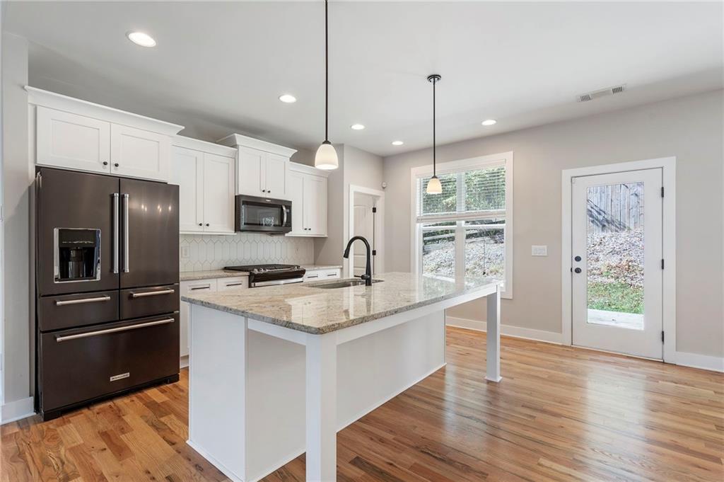 17 Pinoak Trail Cartersville, GA 30121 - Photo 11 of 37 a kitchen with a refrigerator and a sink