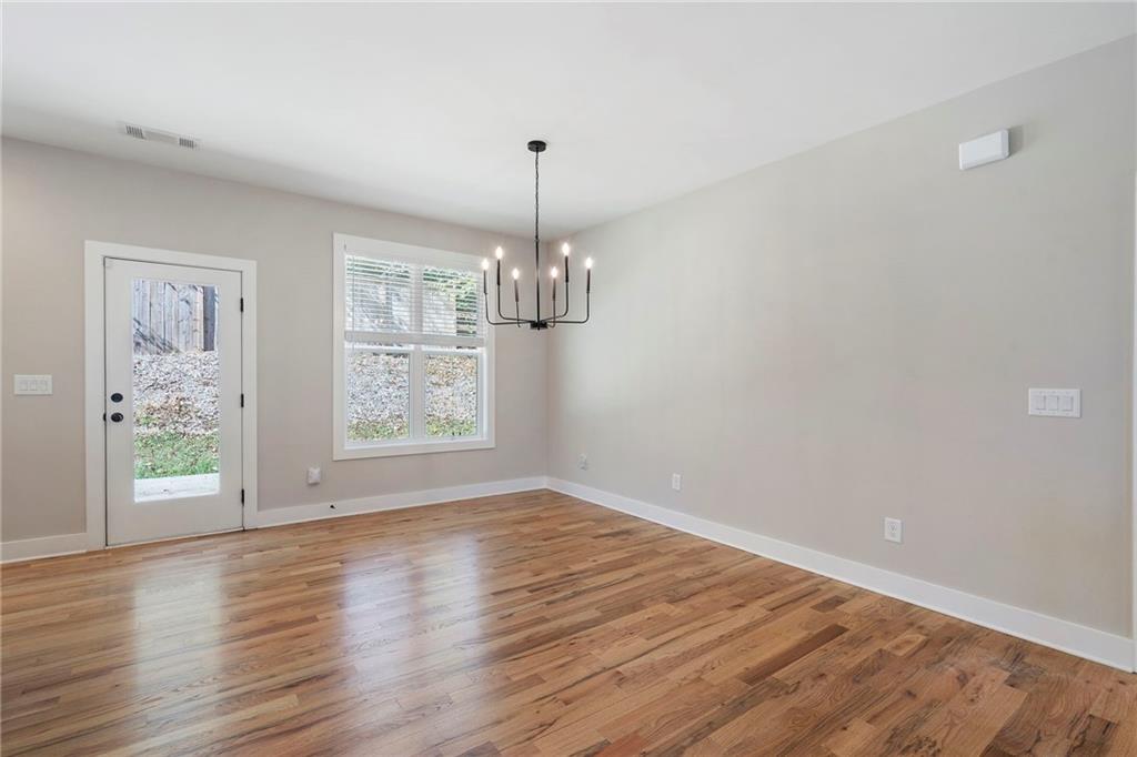 17 Pinoak Trail Cartersville, GA 30121 - Photo 12 of 37 a view of an empty room with wooden floor and a window