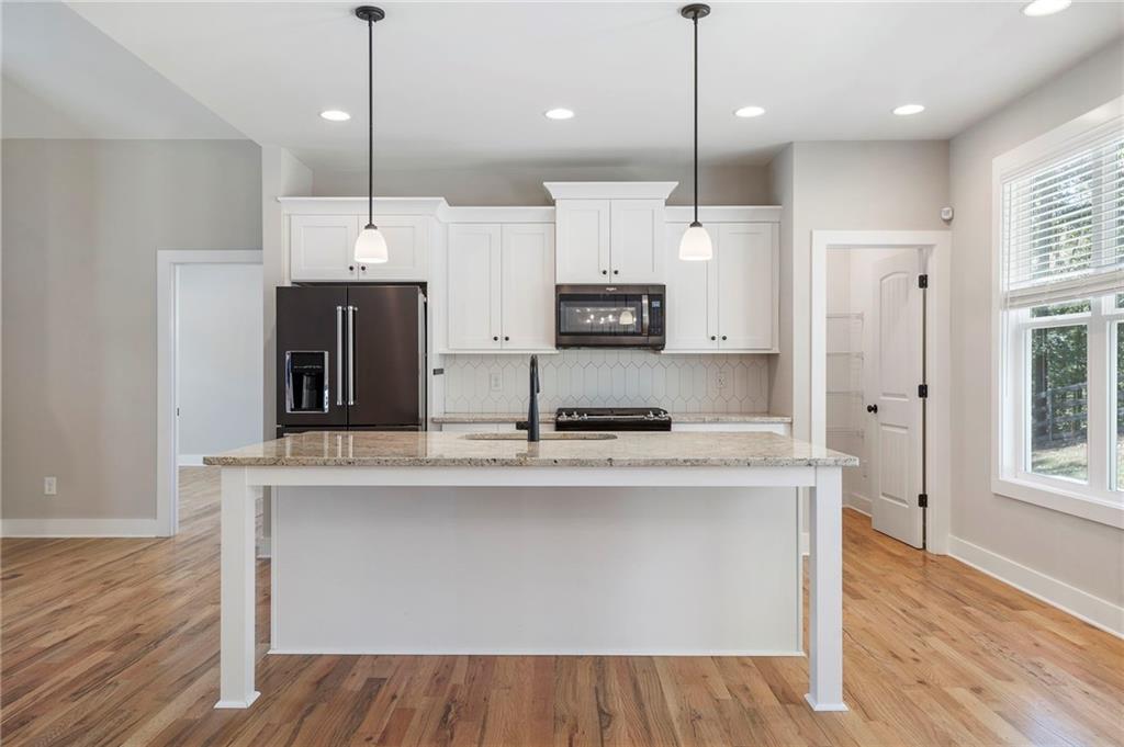 17 Pinoak Trail Cartersville, GA 30121 - Photo 15 of 37 a large kitchen with stainless steel appliances kitchen island a large island in the center