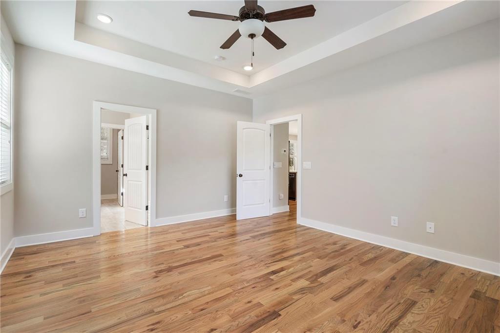 17 Pinoak Trail Cartersville, GA 30121 - Photo 21 of 37 a view of an empty room and wooden floor a ceiling fan