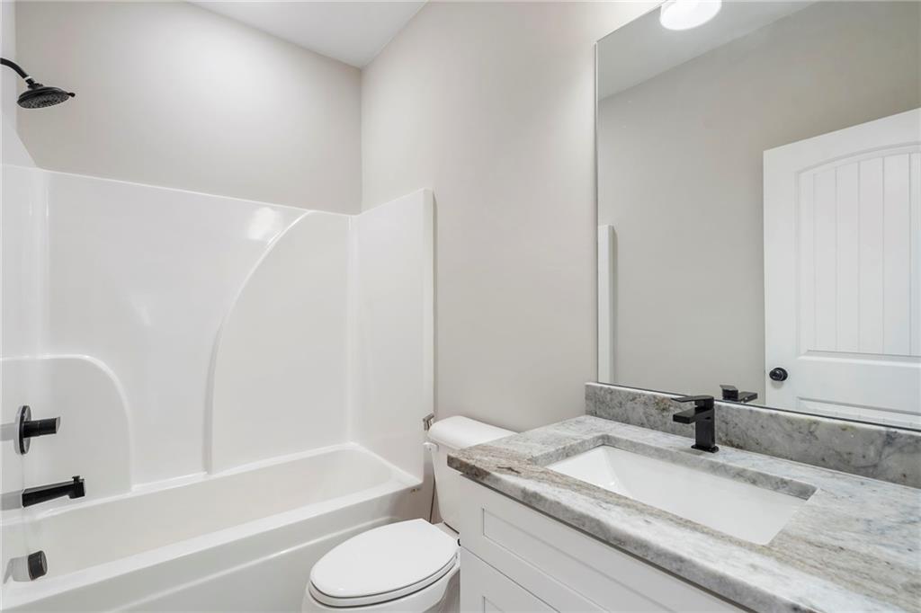 17 Pinoak Trail Cartersville, GA 30121 - Photo 26 of 37 a bathroom with a granite countertop bathtub sink vanity mirror and toilet