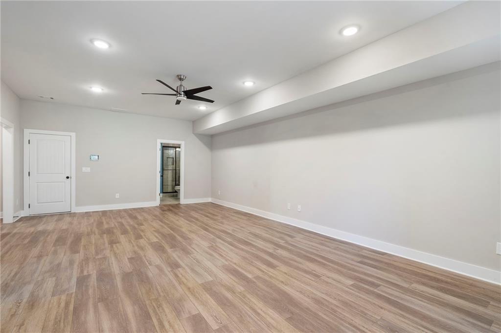 17 Pinoak Trail Cartersville, GA 30121 - Photo 29 of 37 an empty room with a ceiling fan and wooden floor