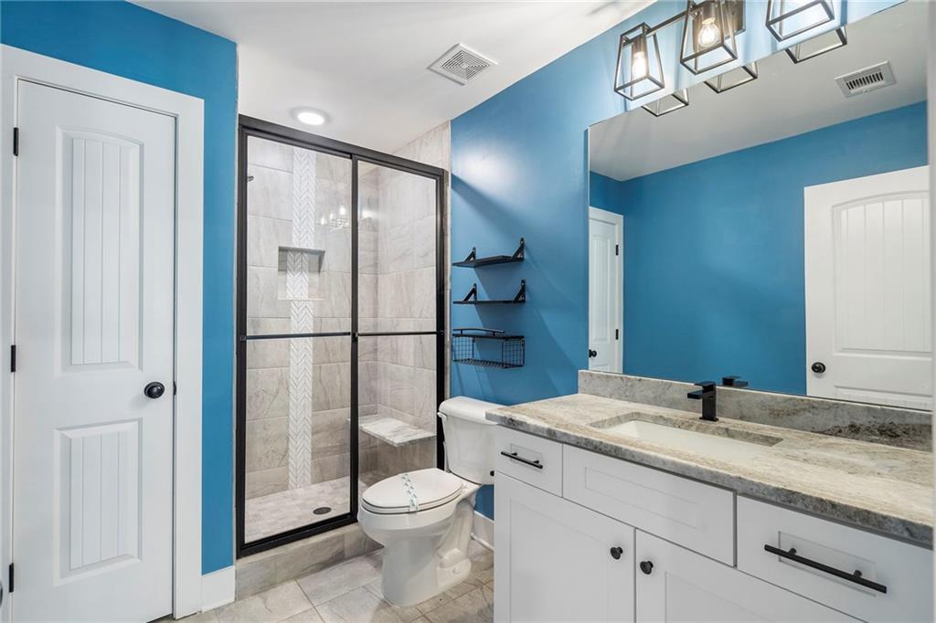 17 Pinoak Trail Cartersville, GA 30121 - Photo 32 of 37 a bathroom with a granite countertop sink a toilet and shower