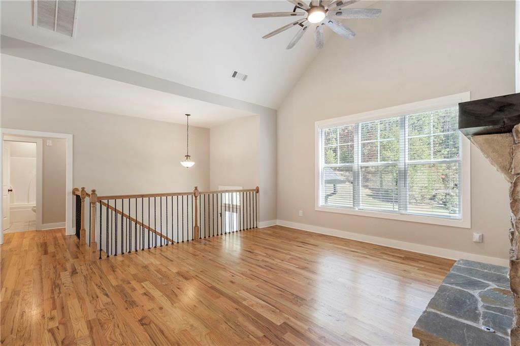 17 Pinoak Trail Cartersville, GA 30121 - Photo 5 of 37 an empty room with wooden floor fan and windows