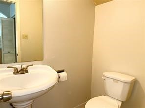 10064 Emnora Lane Houston, TX 77080 - Photo 13 of 31 a bathroom with a sink and a toilet