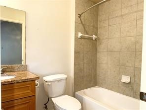 10064 Emnora Lane Houston, TX 77080 - Photo 17 of 31 a bathroom with a granite countertop toilet a sink and shower