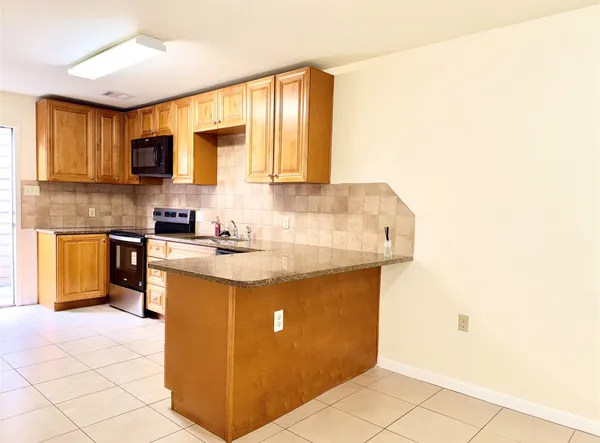 a view of a room with a dishwasher and a window