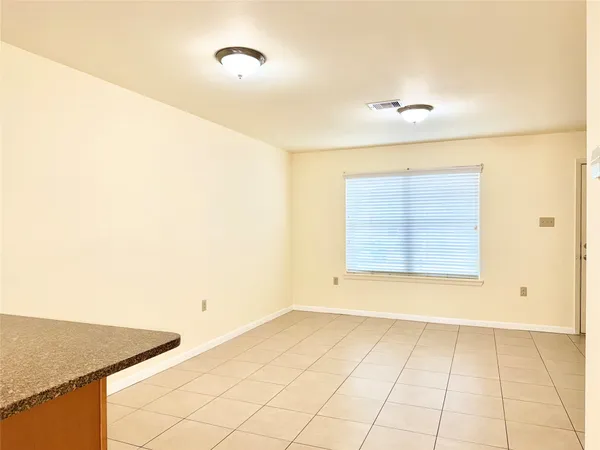 a small white building with a sink