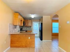 a kitchen with stainless steel appliances granite countertop a sink refrigerator and cabinets