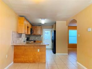 10064 Emnora Lane Houston, TX 77080 - Photo 5 of 31 a kitchen with stainless steel appliances granite countertop a sink refrigerator and cabinets