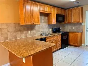 a kitchen with stainless steel appliances granite countertop a sink stove and cabinets