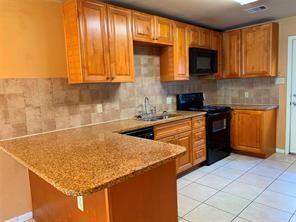 10064 Emnora Lane Houston, TX 77080 - Photo 6 of 31 a kitchen with stainless steel appliances granite countertop a sink stove and cabinets