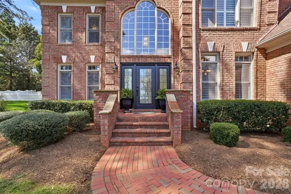 a view of a brick building next to a yard