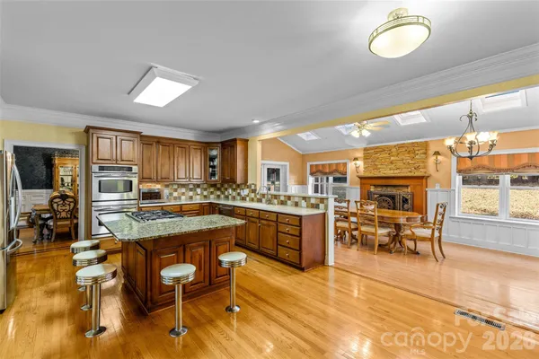 a kitchen with lots of counter top space and dining table chairs