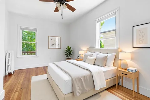 a bedroom with a large bed and a window