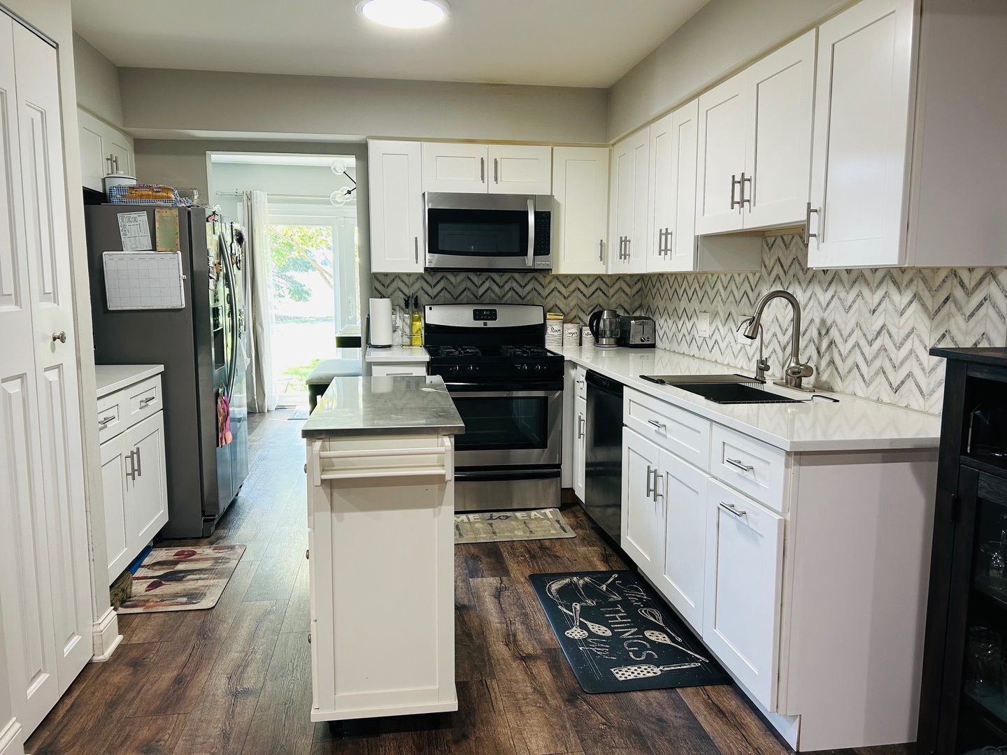 2372 County Farm Lane, Unit E214 Schaumburg, IL 60107 - Photo 3 of 19 a kitchen with stainless steel appliances a refrigerator stove and sink