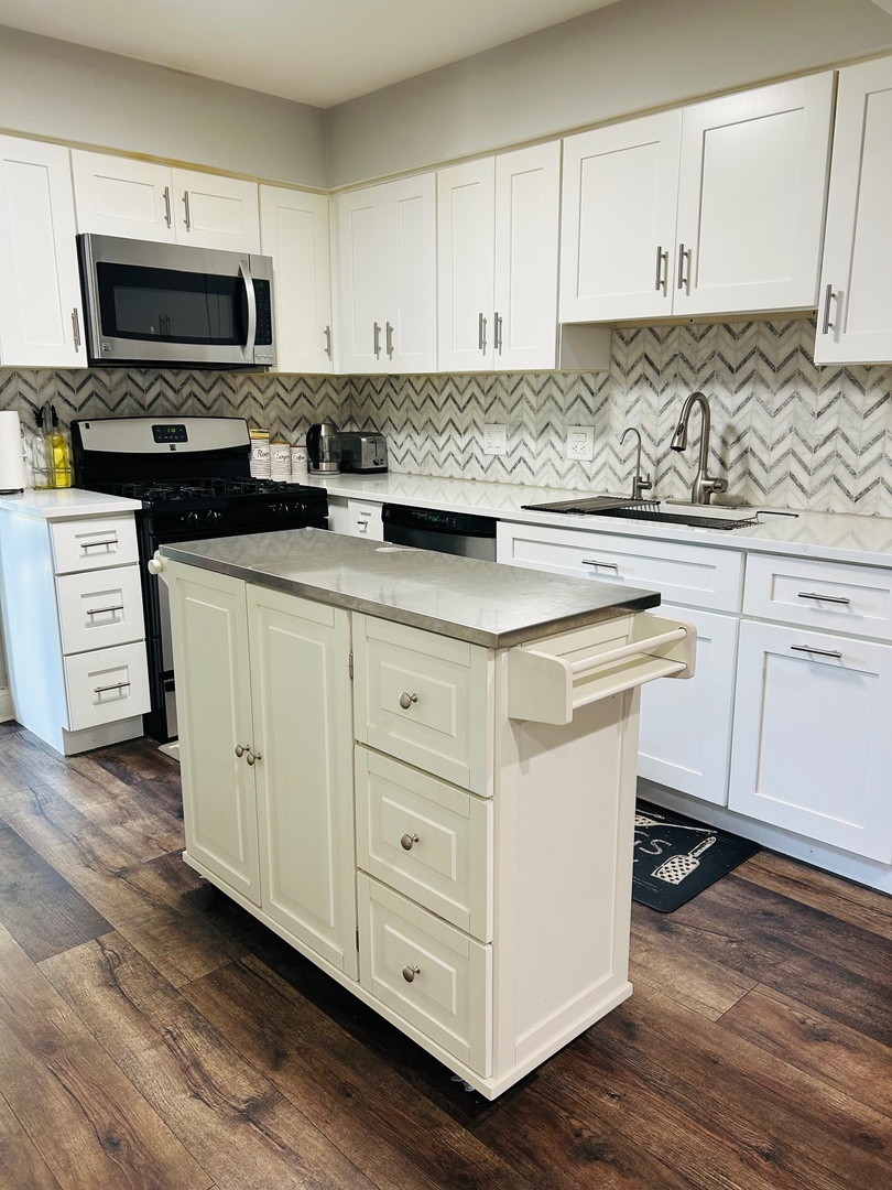 2372 County Farm Lane, Unit E214 Schaumburg, IL 60107 - Photo 4 of 19 a kitchen with stainless steel appliances granite countertop a stove a sink and white cabinets