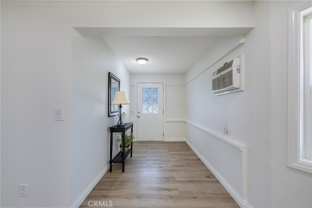 3751 McKenzie Street Riverside, CA 92503 - Photo 12 of 68 a hallway with wooden floor windows and stairs