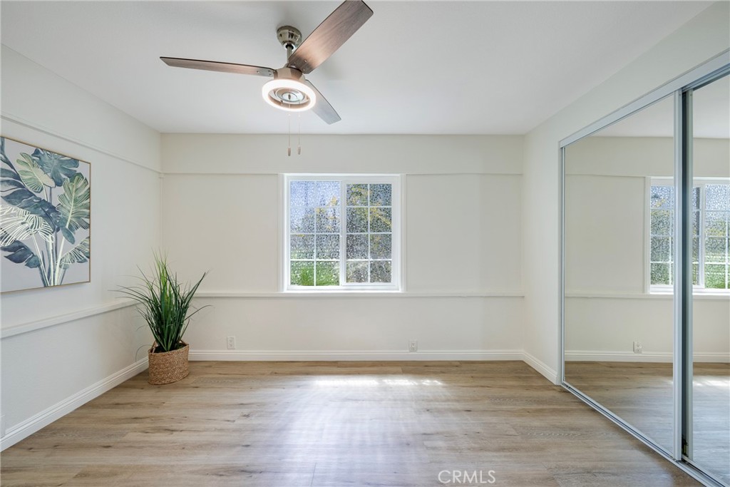 3751 McKenzie Street Riverside, CA 92503 - Photo 18 of 68 a view of an empty room with a window and wooden floor