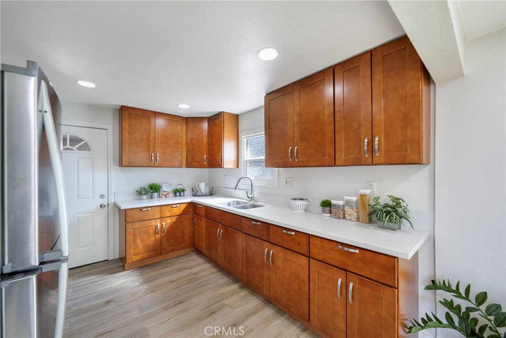 3751 McKenzie Street Riverside, CA 92503 - Photo 22 of 68 a kitchen with stainless steel appliances granite countertop wooden cabinets a sink and dishwasher