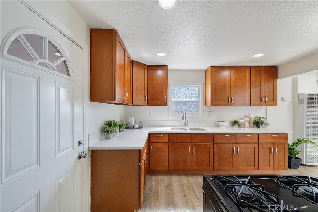 3751 McKenzie Street Riverside, CA 92503 - Photo 24 of 68 a kitchen with a sink stove and cabinets
