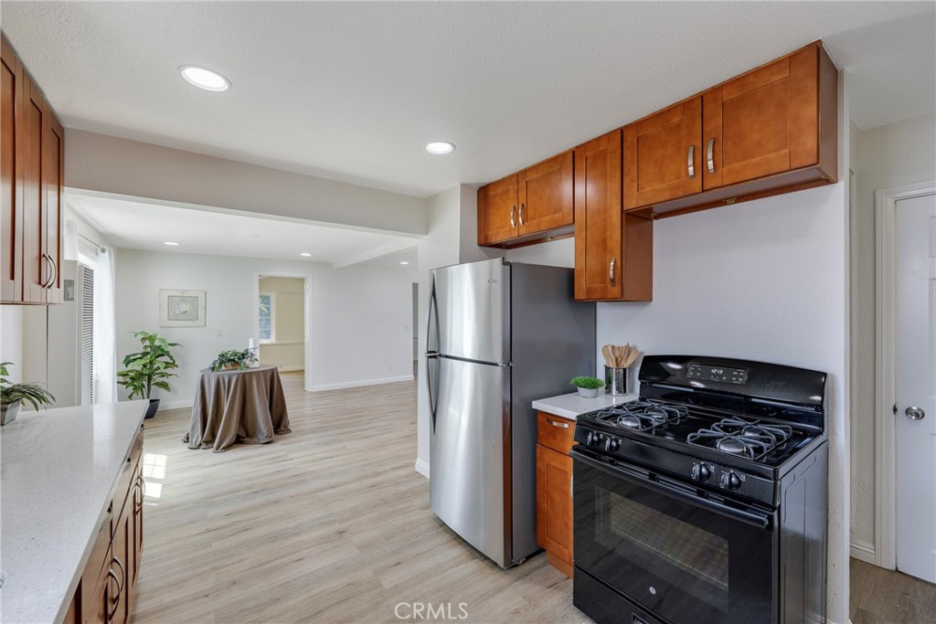 3751 McKenzie Street Riverside, CA 92503 - Photo 25 of 68 a kitchen with granite countertop a stove and a refrigerator