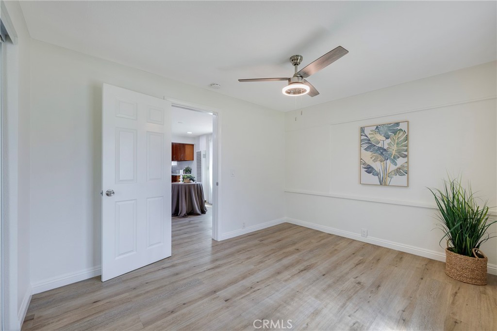 3751 McKenzie Street Riverside, CA 92503 - Photo 26 of 68 an empty room with wooden floor and ceiling fan