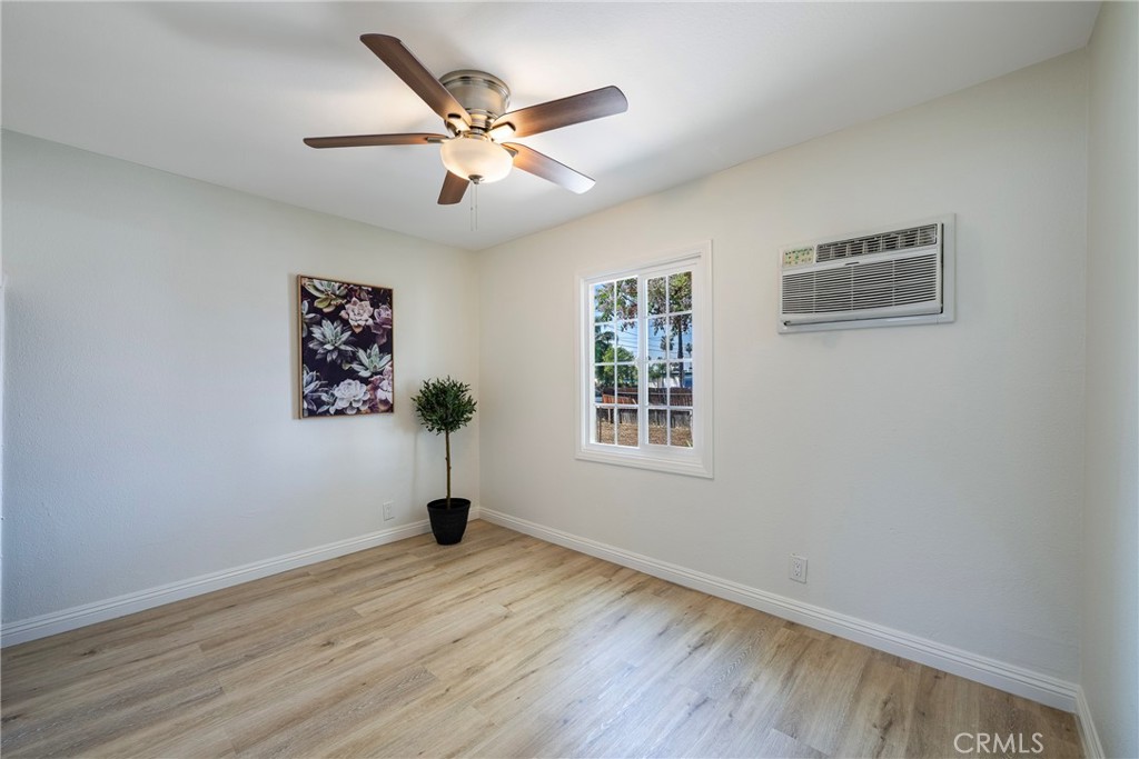 3751 McKenzie Street Riverside, CA 92503 - Photo 27 of 68 a view of an empty room with wooden floor and a window