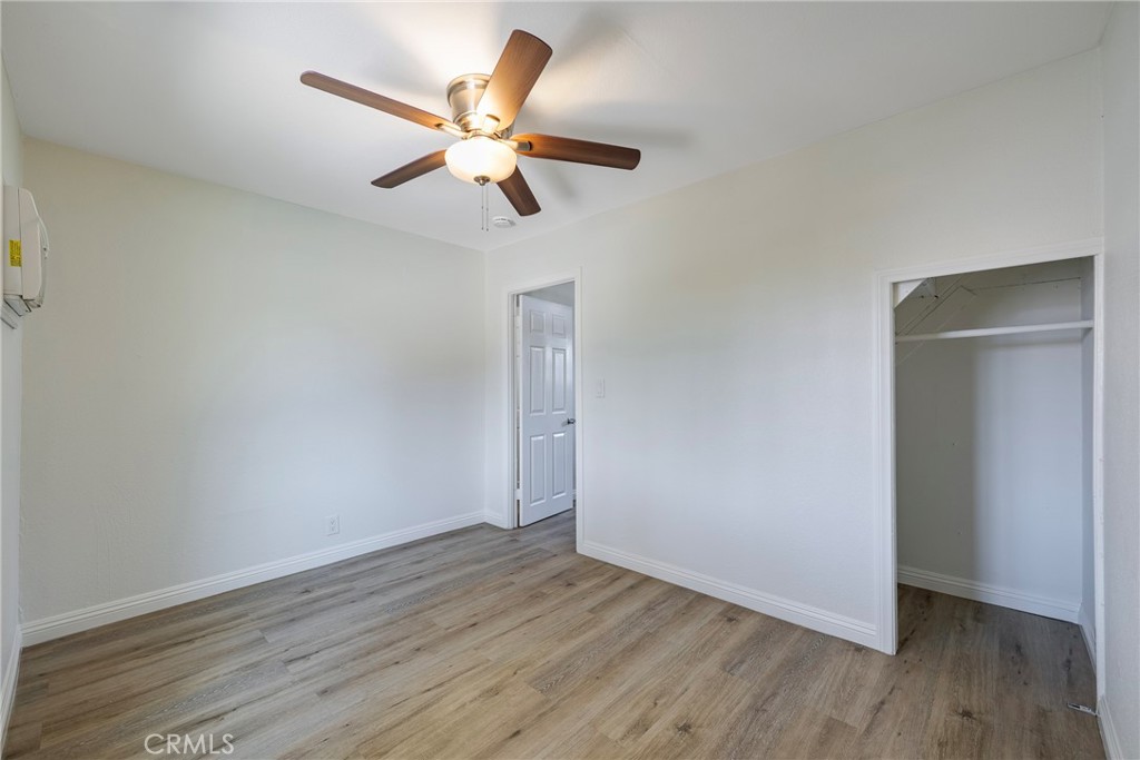 3751 McKenzie Street Riverside, CA 92503 - Photo 29 of 68 an empty room with wooden floor ceiling fan and window