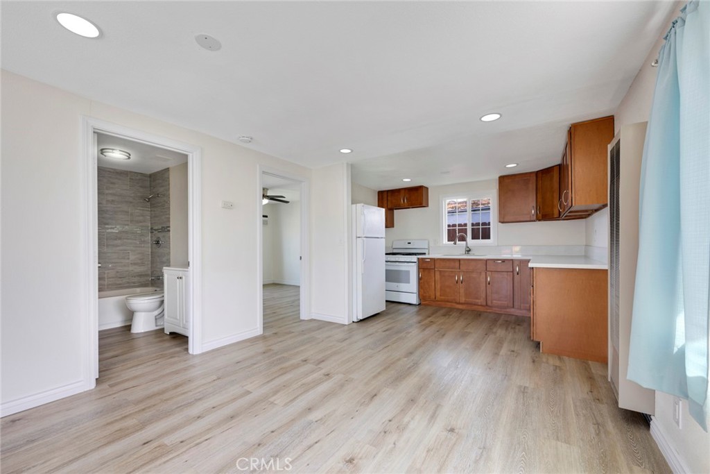 3751 McKenzie Street Riverside, CA 92503 - Photo 47 of 68 a kitchen with stainless steel appliances a refrigerator and wooden floor