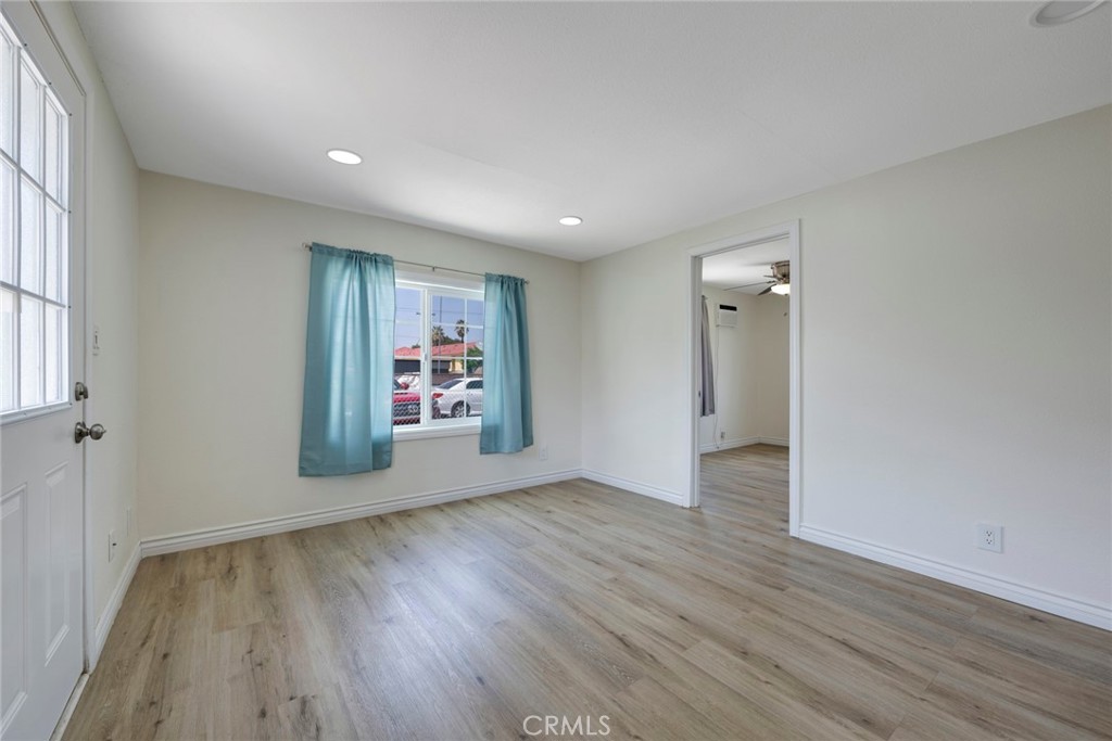 3751 McKenzie Street Riverside, CA 92503 - Photo 51 of 68 an empty room with wooden floor and windows