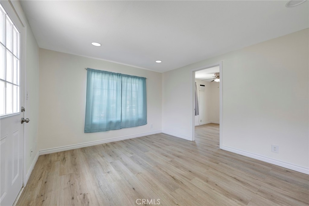3751 McKenzie Street Riverside, CA 92503 - Photo 53 of 68 an empty room with wooden floor and windows