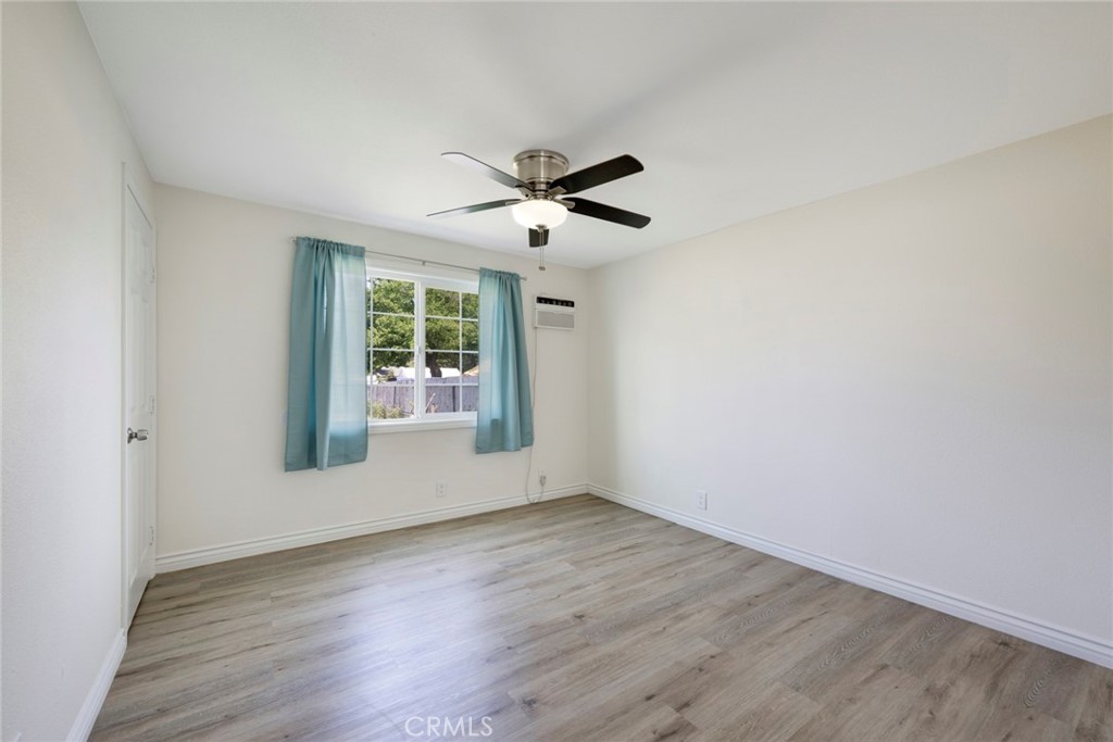 3751 McKenzie Street Riverside, CA 92503 - Photo 57 of 68 an empty room with wooden floor ceiling fan and windows