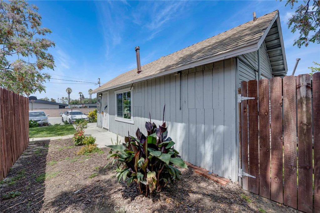 3751 McKenzie Street Riverside, CA 92503 - Photo 59 of 68 a backyard of a house with table and chairs plants and large tree