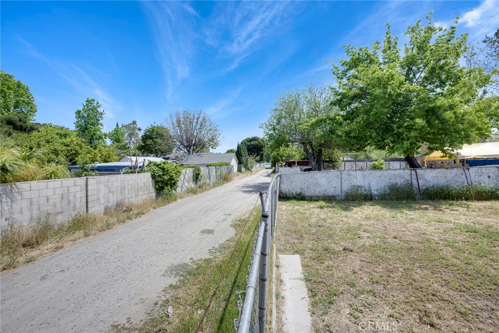 3751 McKenzie Street Riverside, CA 92503 - Photo 66 of 68 a view of a pathway of a yard and a wooden fence