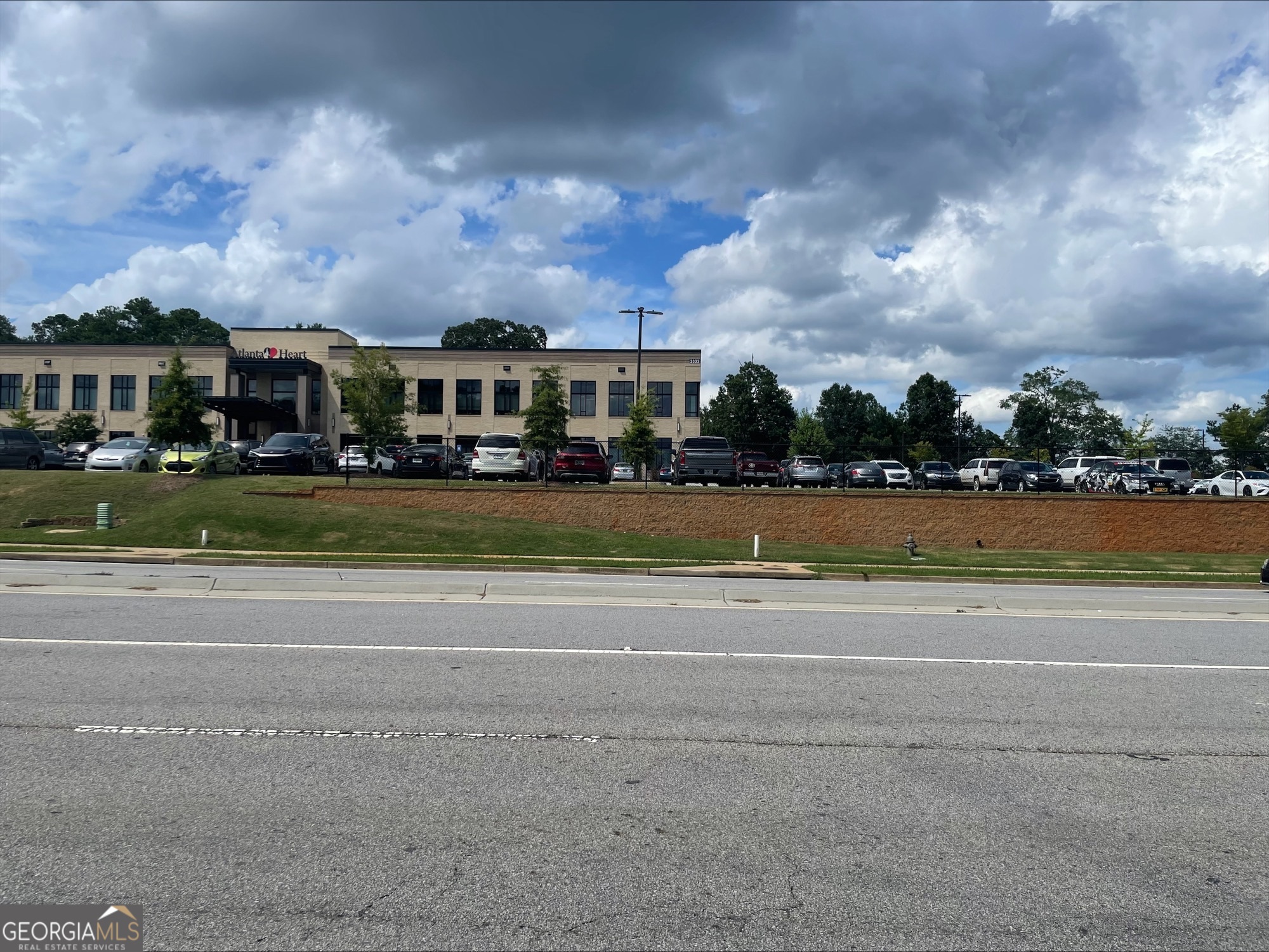 0 Jodeco Road, Unit LOT 16 McDonough, GA 30253 - Photo 3 of 4 a view of a big house with a big yard and large trees