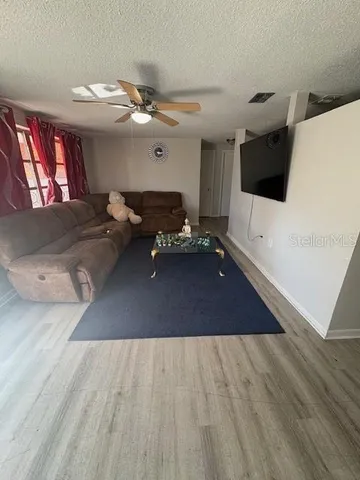 a living room with furniture and wooden floor