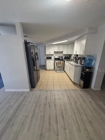 a view of a kitchen with wooden floor
