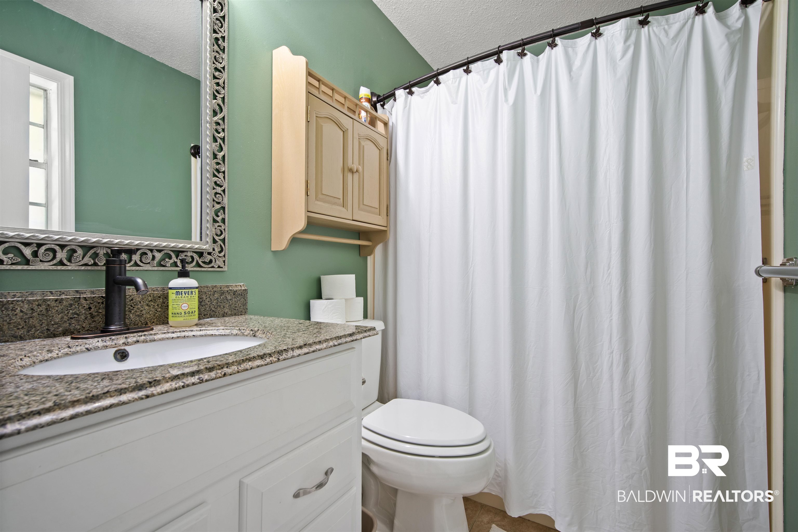 1325 Pawnee Circle Saraland, AL 36571 - Photo 14 of 26 Full bathroom with vanity, a textured ceiling, and curtained shower