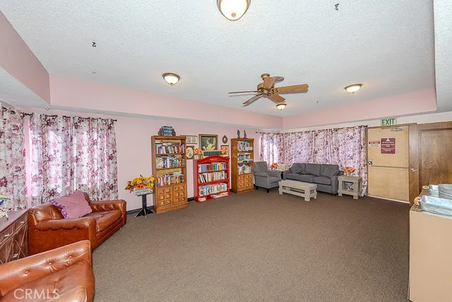 a view of a livingroom with furniture and a ceiling fan