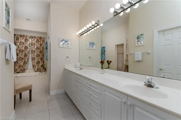 a bathroom with a double vanity sink and a mirror